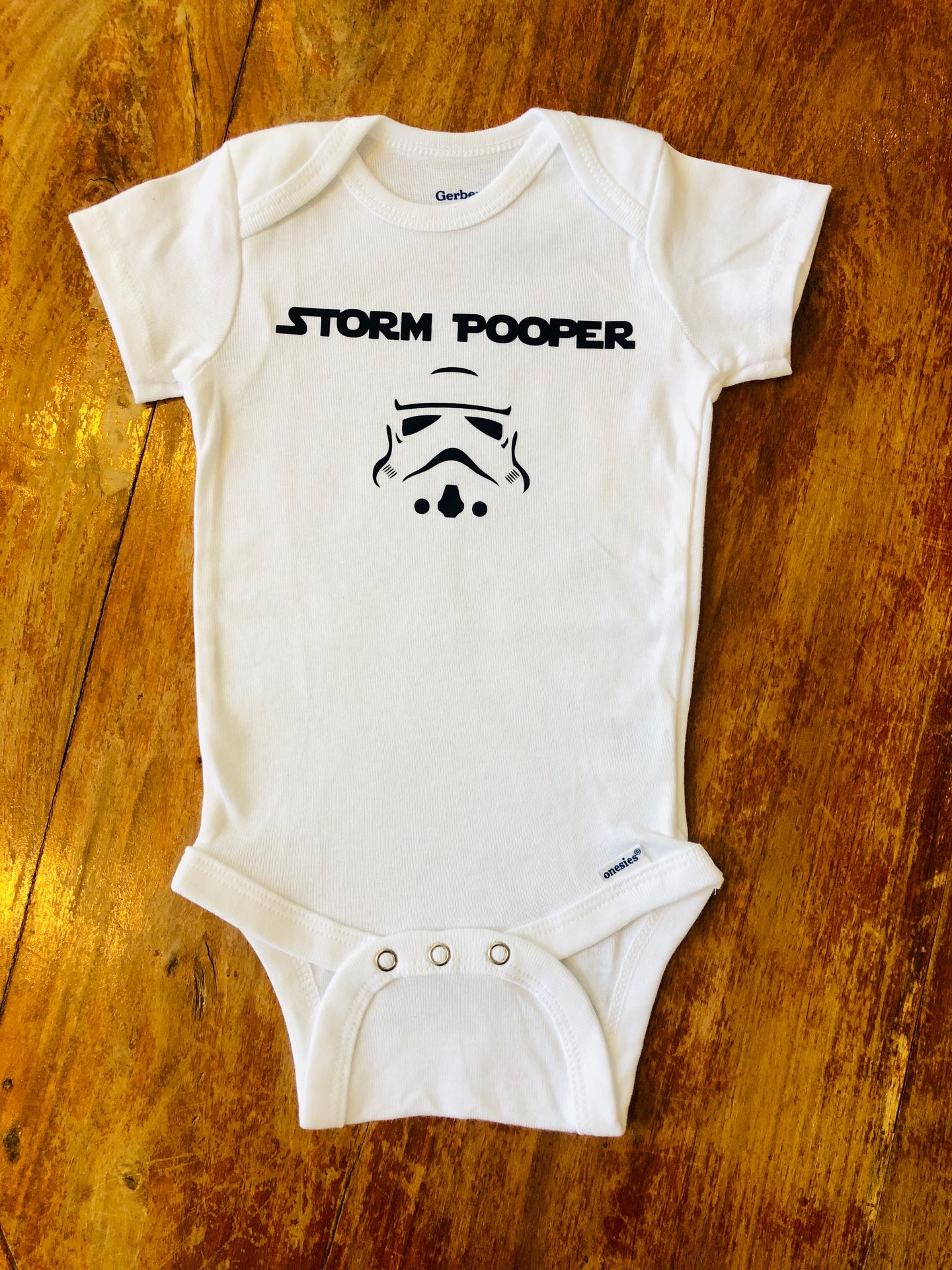 Storm Pooper - Gerber brand onesie available in sizes from 0-24 months.